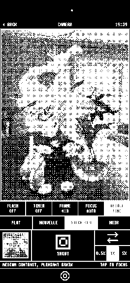 The 1bit camera on iPhone showing a portrait rendered live in black and white pixels.